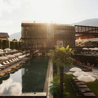 Wellness Tower con piscina sportiva, lettini prendisole e giardino dell’hotel all’alba