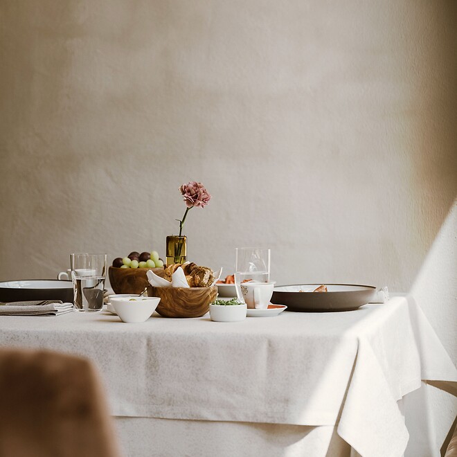 Generously set breakfast table with fresh flowers