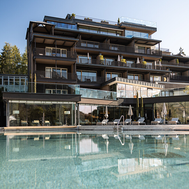 Hotel facade and natural pool in the garden