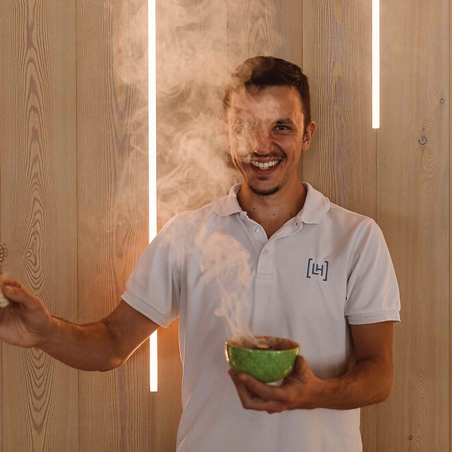 Man with steaming bowl for smoking during wellness rituals