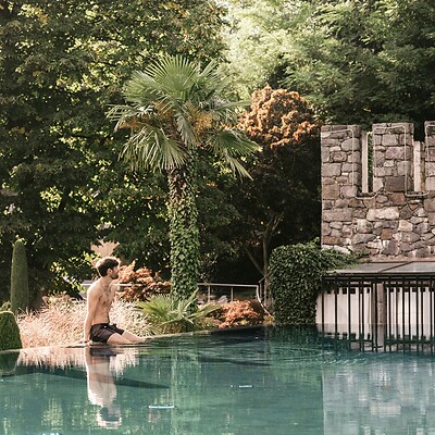 Man sitting by the sport pool in the garden