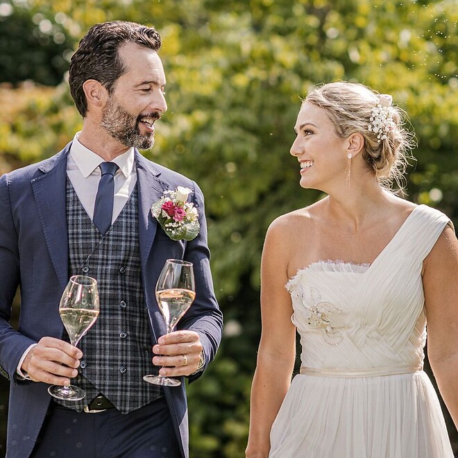 Man and woman getting married in garden with champagne reception