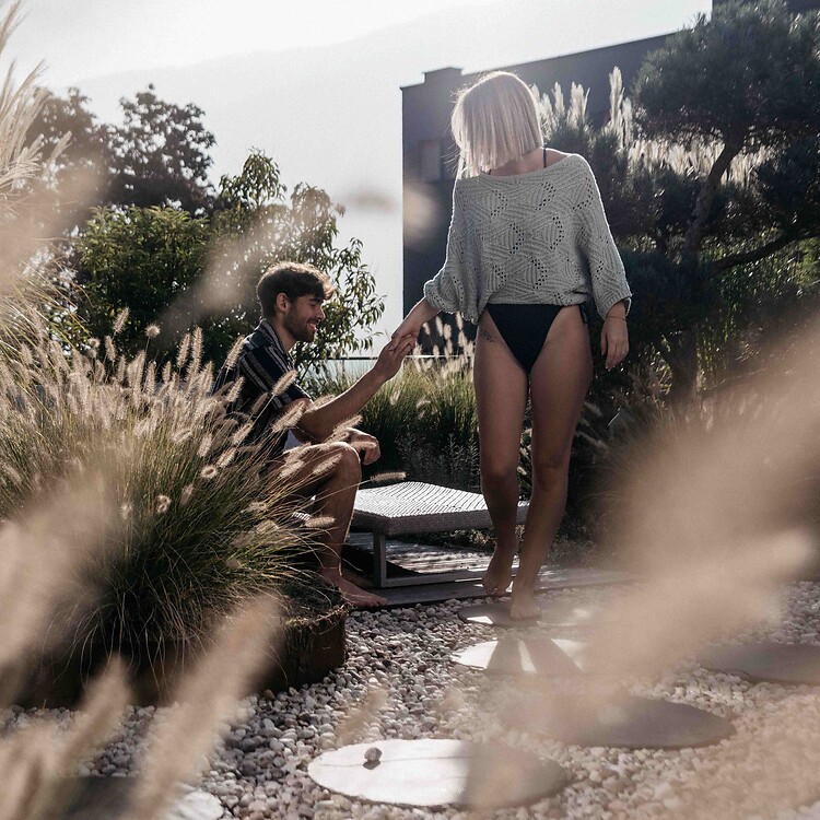 Man and woman in the thermal garden with spring grasses