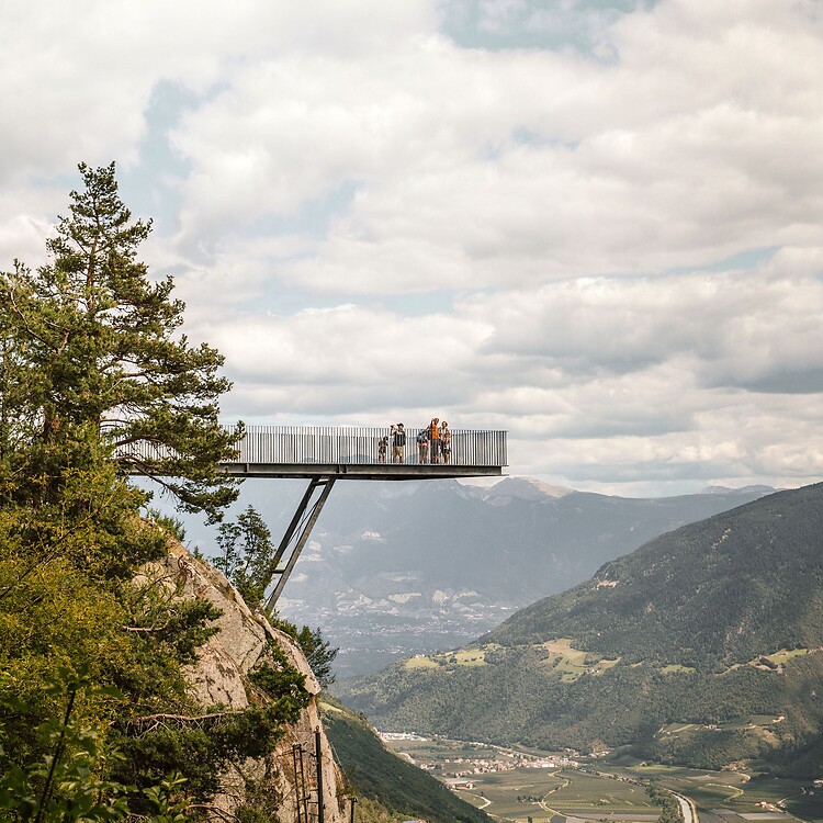 Family on the Unterstell viewpoint overlooking the Vinschgau valley and mountains