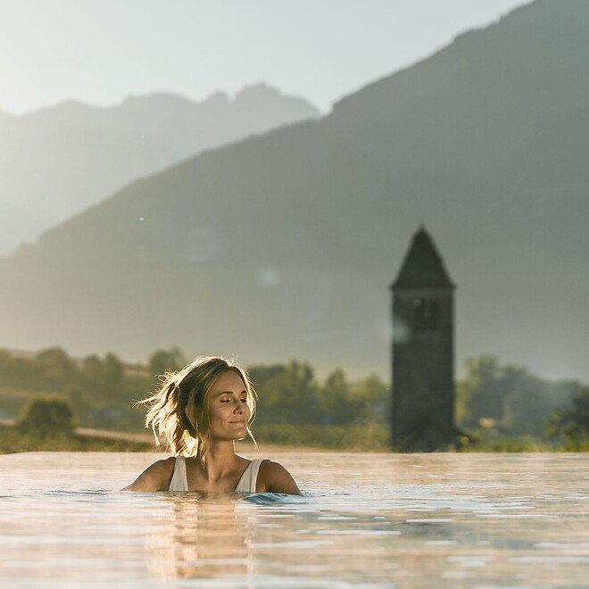 Woman in the Infinity Sky pool with a view