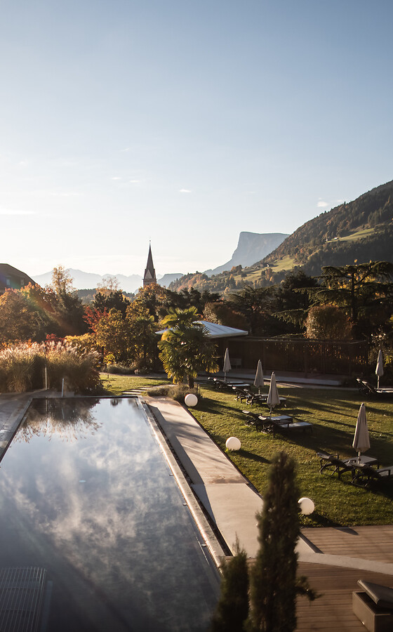 Outdoor infinity pool and hotel garden in autumn