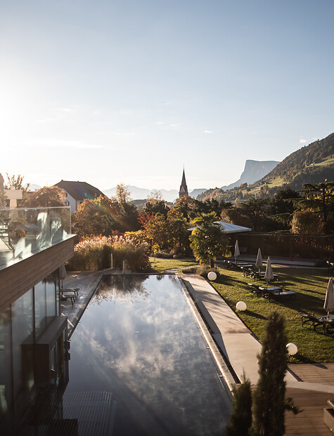 Outdoor infinity pool and hotel garden in autumn